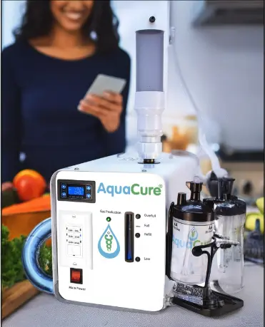 AquaCure AC50 hydrogen generator on a kitchen counter, connected for hydrogen-infused water